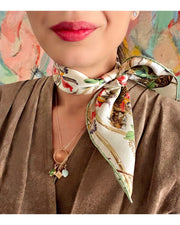 close up of classic woman wearing luxury, bespoke Elwyn New York silk bandana around her neck with vintage tropical, floral, bamboo, leopard wall paper print