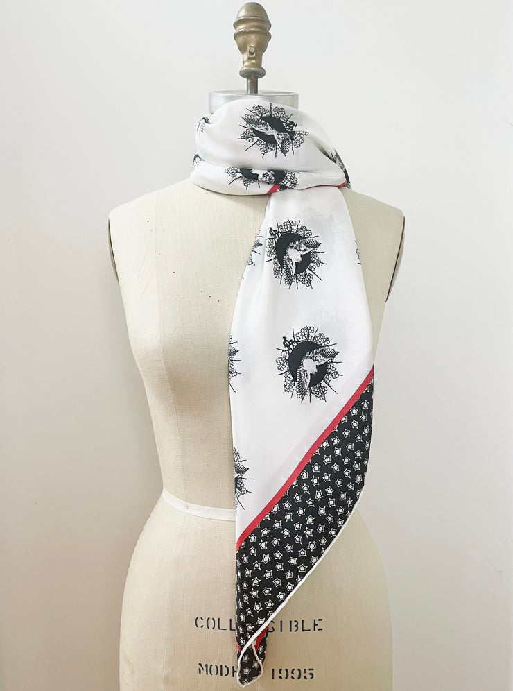 dress form with a luxury, bespoke Elwyn New York silk scarf around her neck with black and white, whimsical, polka dot, bird and stars, storybook print