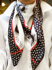 classic woman wearing a luxury, bespoke Elwyn New York silk scarf around her neck with black and white, whimsical, polka dot, bird and stars, storybook print