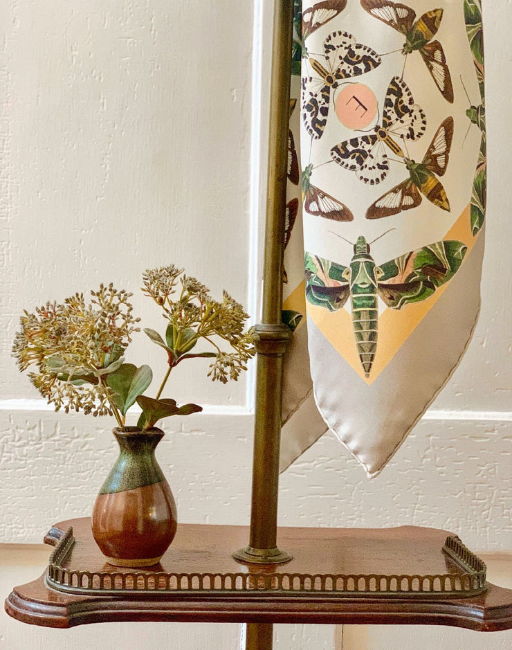 details of a  luxury, bespoke Elwyn New York silk scarf geometric butterfly vintage modern style print hanging 