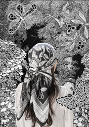 classic female traveler standing in an illustrated blooming garden, wearing bespoke, luxury, black and white Elwyn New York silk scarf on her head with vintage lace print and graphic fringe border
