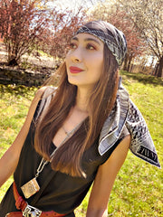 a classic woman wearing a luxury, bespoke, black and white Elwyn New York silk scarf on her head with vintage modern style graphic needlework and crochet print