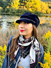Classic woman standing in front of a lake, surrounded by goldenrod wild flowers, wearing bespoke, luxury Elwyn New York silk scarf loosely looped around her neck. This geometric crazy quilt print is a vintage-modern depiction of the year 2020 filled with digital embroidery and lace of years past.