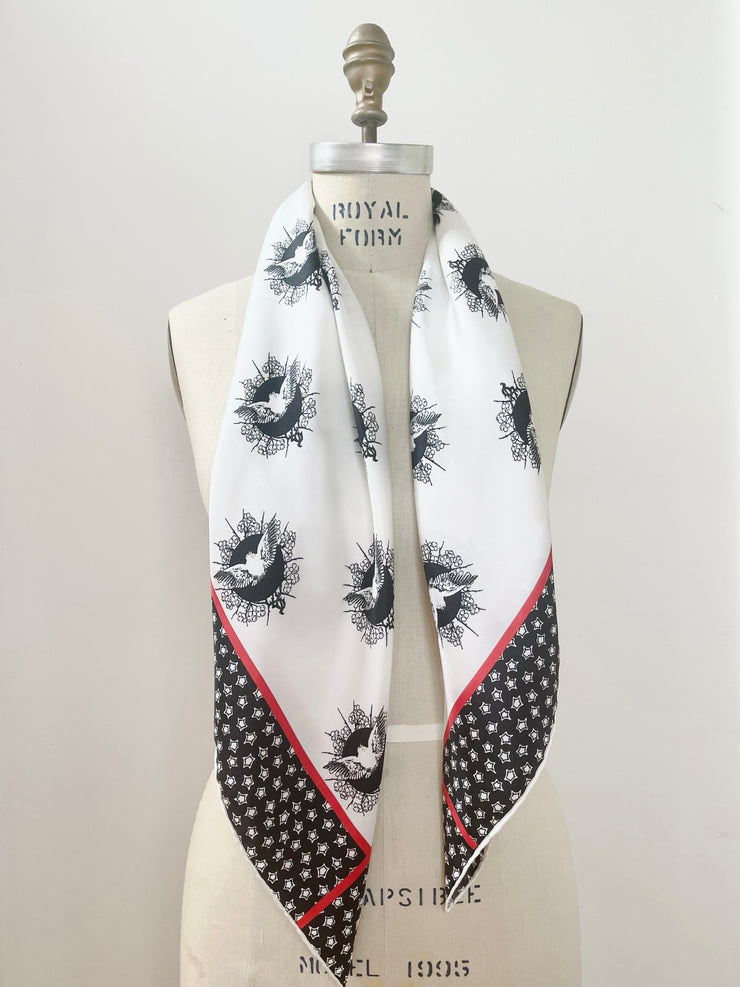 dress form with a luxury, bespoke Elwyn New York silk scarf around her neck with black and white, whimsical, polka dot, bird and stars, storybook print