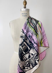 A luxury, bespoke Elwyn New York silk scarf draped on one shoulder of a form with a fierce tiger and pastel lavender, peach, green, black stripe print
