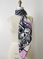 A luxury, bespoke Elwyn New York silk scarf thrown around the neck of a form with a fierce tiger and pastel lavender, peach, green, black stripe print