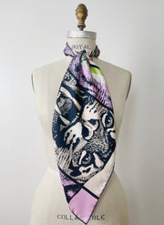 A luxury, bespoke Elwyn New York silk scarf knotted at the neck of a form with a fierce tiger and pastel lavender, peach, green, black stripe print