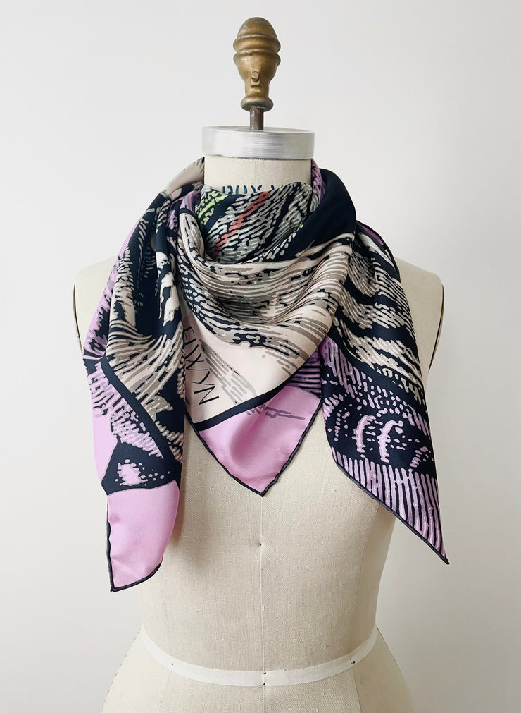 A luxury, bespoke Elwyn New York silk scarf wrapped around the neck of a form with a fierce tiger and pastel lavender, peach, green, black stripe print