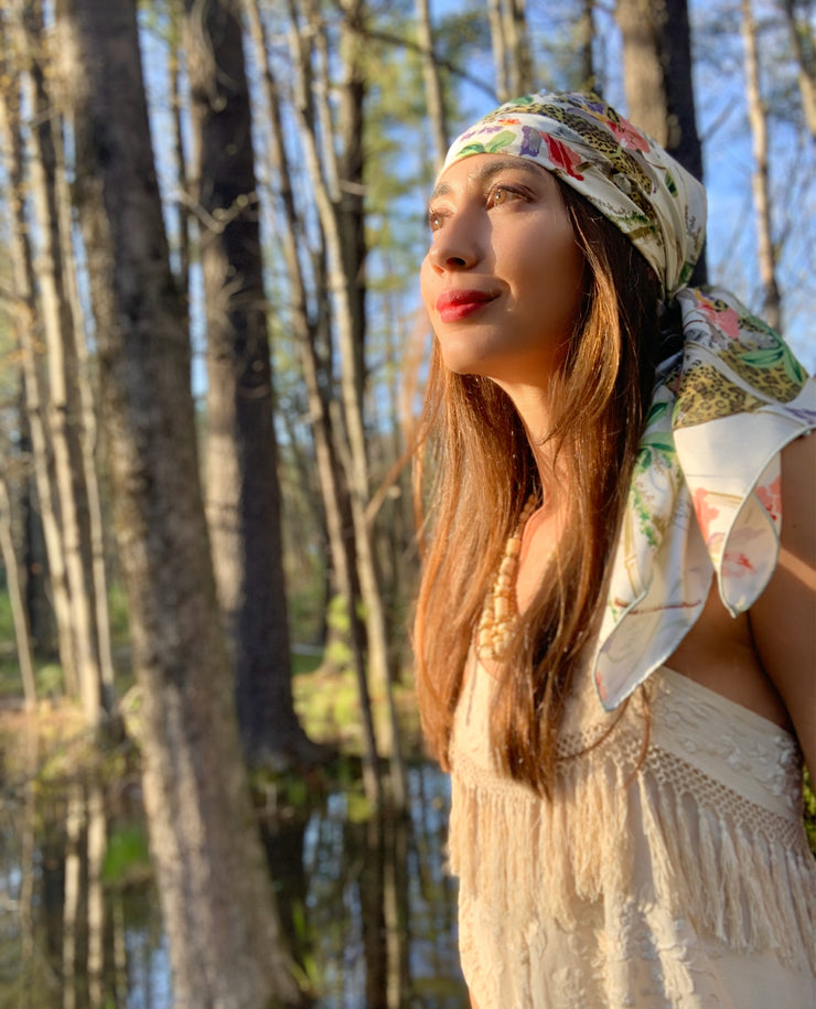 Side View of a classic woman in the middle of the woods, wearing a luxury, bespoke Elwyn New York silk scarf on her head with vintage tropical, floral, bamboo, leopard wall paper print