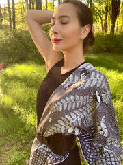 classic woman in the middle of the forest wearing bespoke, luxury, black and white Elwyn New York silk scarf around her neck with butterflies and vintage lace print draped on her shoulder and belted