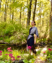 classic woman in the middle of the forest wearing bespoke, luxury, black and white Elwyn New York silk scarf around her neck with butterflies and vintage lace print draped on her shoulder and belted 