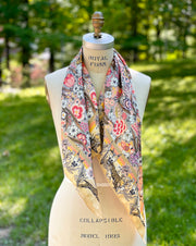 A classic dress form with an Italian silk scarf is rich with sunset colored wildflowers and energized leopards romping around the border draped around the neck.  The main print is dappled with tiny little dots better known in the textile world as "Picotage"