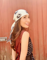 classic woman wearing a luxury, bespoke Elwyn New York silk scarf on her head with black and white, whimsical, polka dot, bird and stars, storybook print