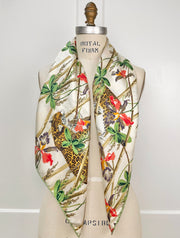 luxury, bespoke Elwyn New York silk scarf draped on both sides of the neck of a form with vintage tropical, floral, bamboo, leopard wall paper print