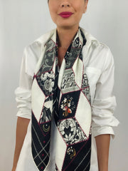 Classic woman wearing bespoke, luxury Elwyn New York silk scarf draped long and loose around her neck. This geometric crazy quilt print is a vintage-modern depiction of the year 2020 filled with digital embroidery and lace of years past. One can see the word GROW depicted in this photo