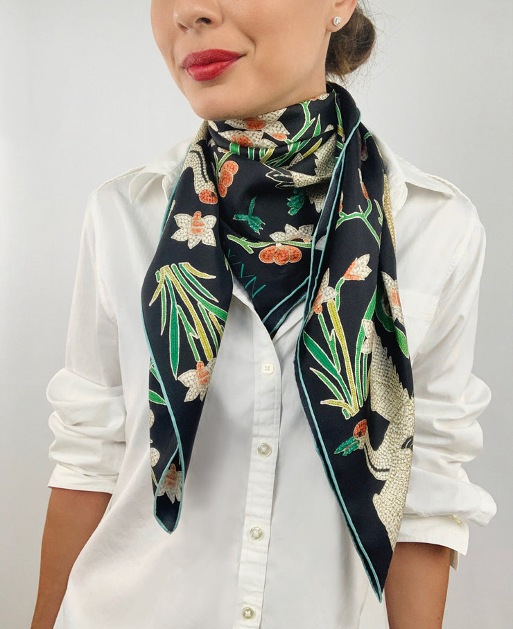 Classic woman wearing bespoke Elwyn New York Scarf draped in a loop around her neck with a botanical crane print is collaged together from antique glass and pearl, beaded embroideries of yesteryear.