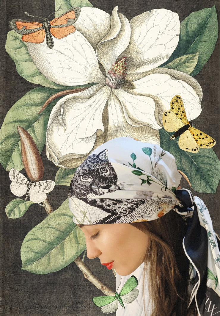 classic female surrounded by a fantastical illustration of flora and butterflies, wearing a luxury, bespoke Elwyn New York silk scarf on her head  with vintage style, botanical, floral, butterfly and leopard print