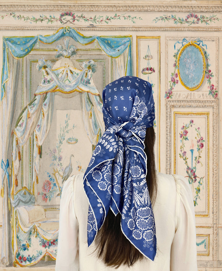 fantasy vintage boudoir illustration of a classic woman wearing a bespoke Elwyn New York Scarf on her head with an ornate, blue and white, vintage-pastoral bandana design. Classic, feminine, and romantic