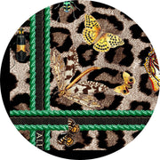 Closeup of a personalized designer silk scarf .  The customer's initials can be seen. The Italian silk scarf Features a Leopard fur print, adorned with multicolored entomological moths, butterflies, beetles, and dragonflies and framed by a rope ribbon border.  Imagined to be a sleeping Leopard, where butterflies and the such come to land and rest on her back in a daydream...  