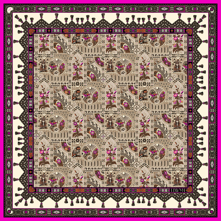 An Italian silk scarf with an Anglo-Japanesque print with intersecting geometric forms, framing little garden, owl and cat motifs, surrounded by a woven ribboned border and dangling tassels with pops of fuchsia and orange throughout.
