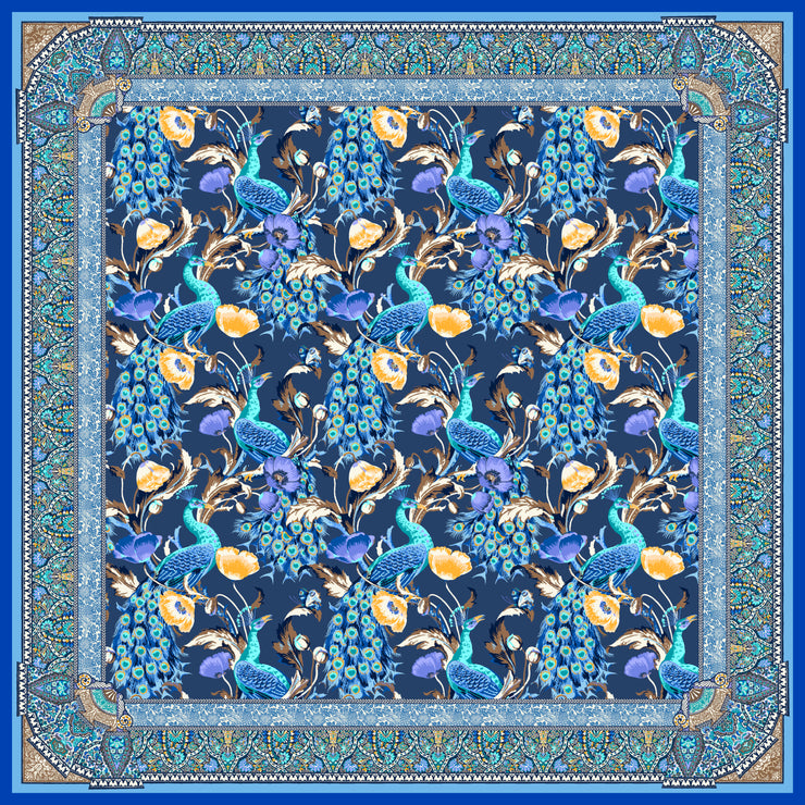 An Italian silk scarf designed in New York with a wallpaper type print, featuring radiant peacocks, amidst sprigs of yellow poppies, surrounded by ornate ribbons folding around the border.